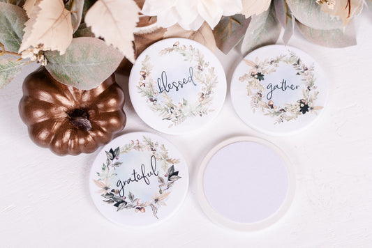 Set of four autumn wreath coasters with seasonal sentiments on white background and felt backing