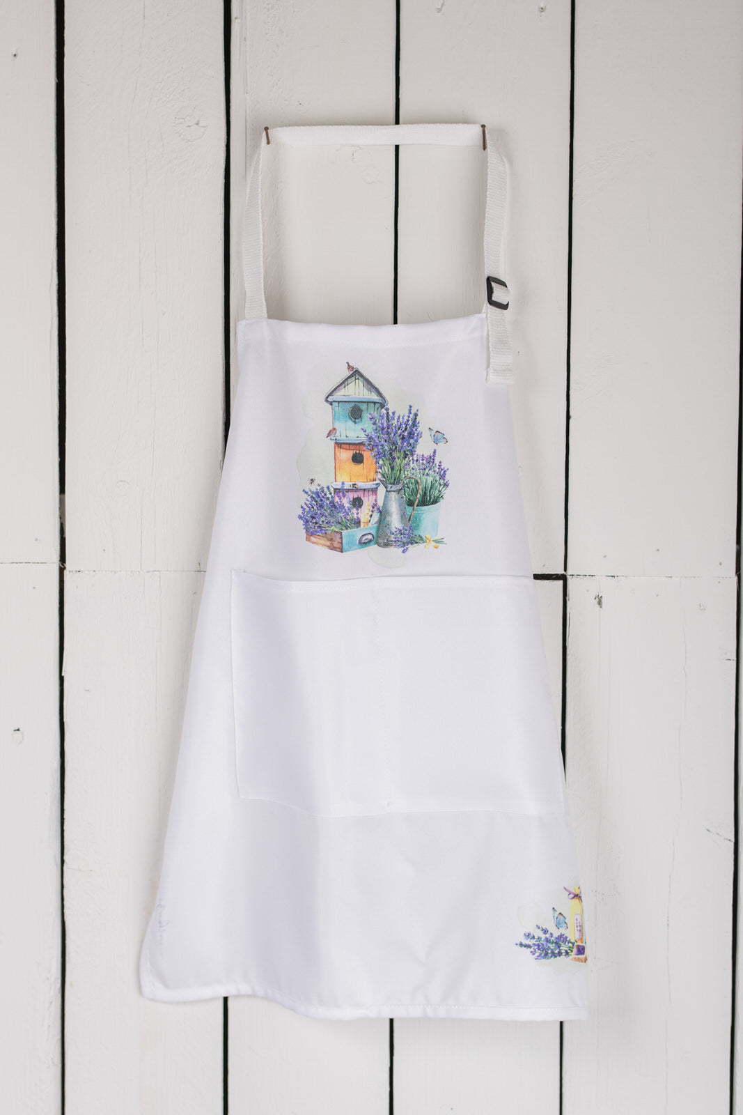 Floral child’s apron hung from farmhouse hook
