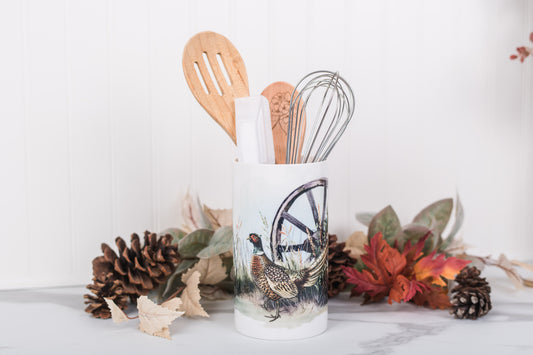 Kitchen utensil holder with wooden utensils on a decorative background with fall elements.