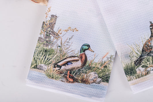 Waffle weave kitchen towel with a duck design on a white background
