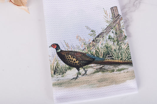 Towel with a pheasant design with rustic fence on a white background