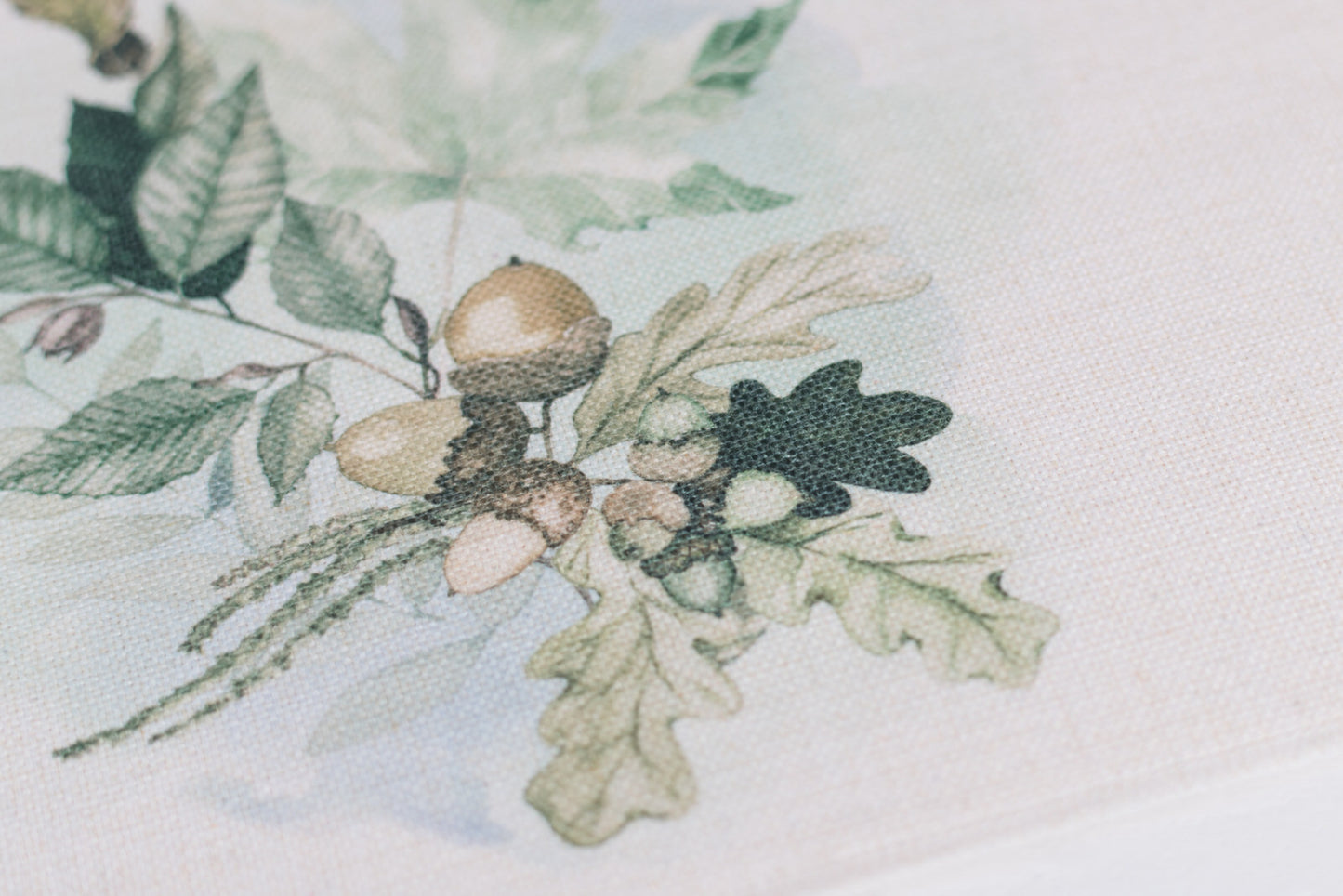 Set of neutral fall placemats with oak leaf prints on a table