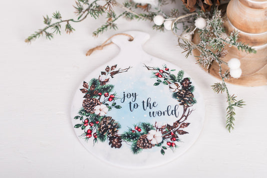 Round Christmas spoon rest with holly berries, pinecones, and greenery