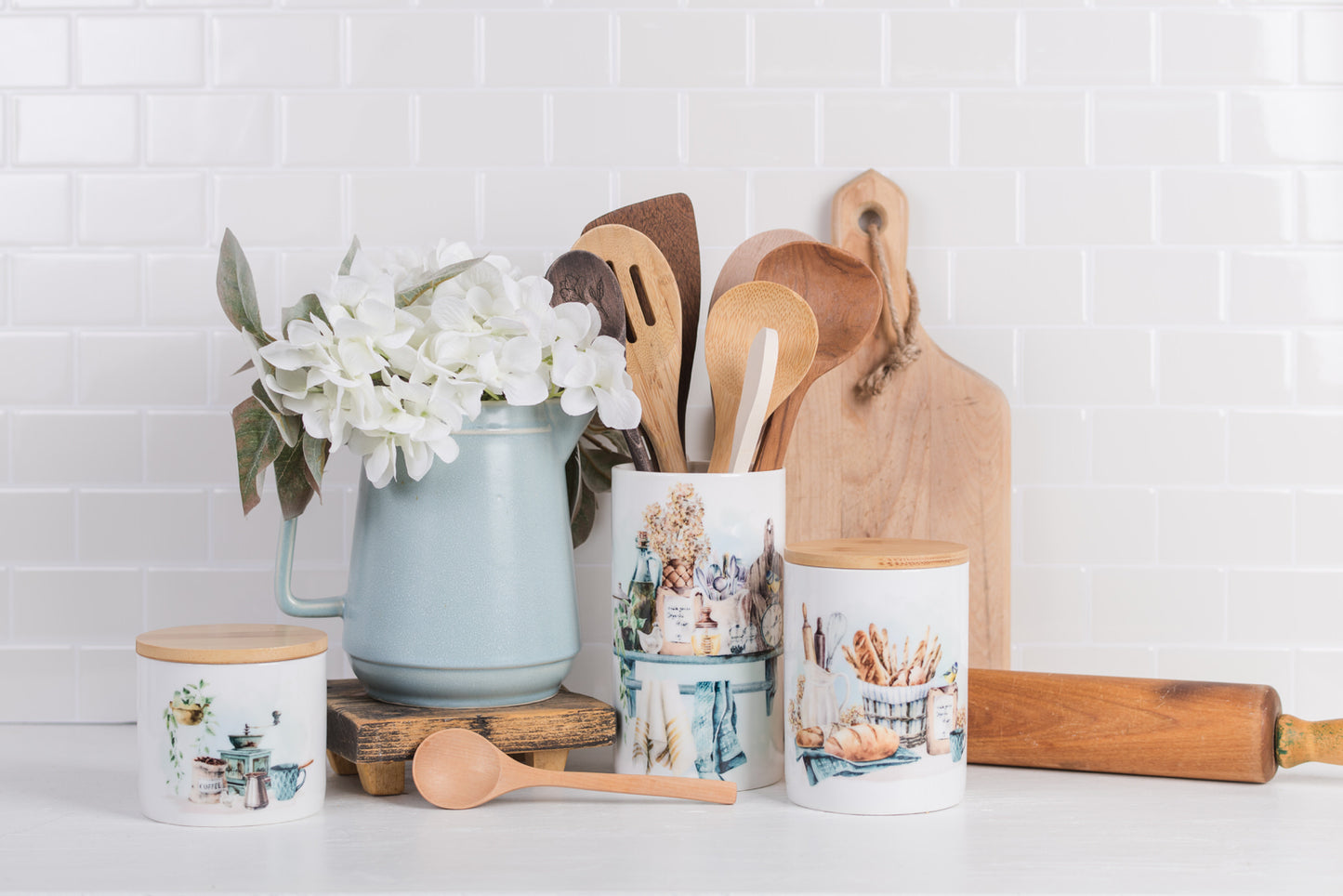 Set of three ceramic jars styled on a kitchen counter.