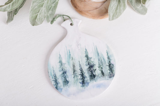 Forest-themed round spoon rest styled with greenery and wood decor