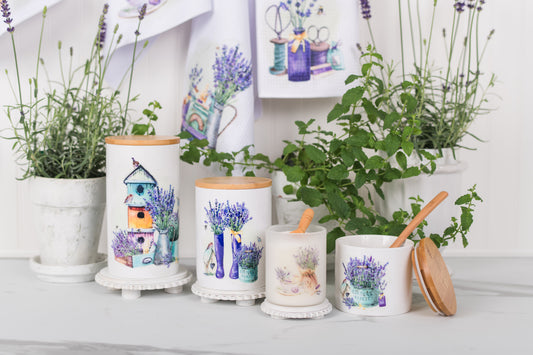 set of ceramic canisters with watercolour lavender on a counter with plants