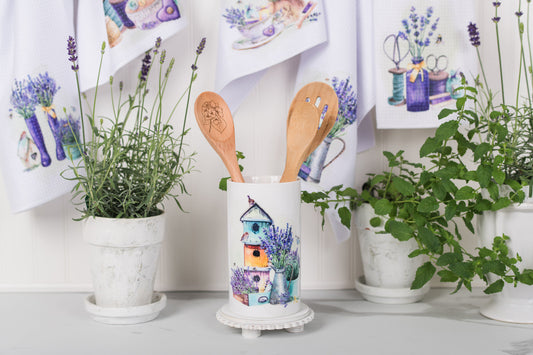 Large ceramic canister holding wooden utensils