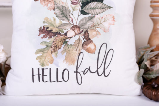 Close-up of hello fall script on a fall Oakleaf an acorn on a velveteen pillow cover