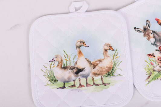 Set of pot holders with duck design on a white background