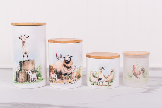 Four ceramic jars with animal-themed designs on a white surface
