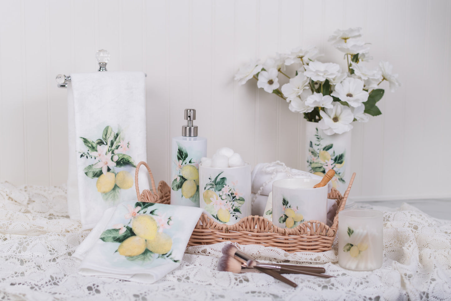 lemon, bathroom, canisters, jars, hand towels, soap, holder, and a vase styled on a lace background
