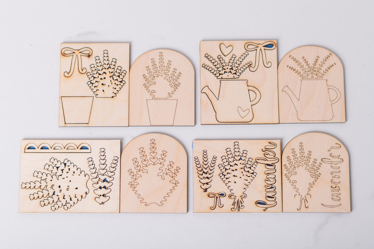 Set of wooden laser-cut lavender inserts with garden designs on a light gray background