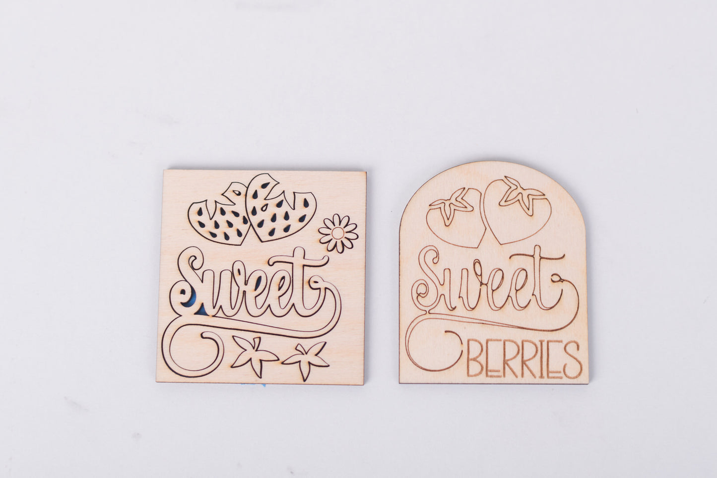 Two wooden kits with 'sweet' and 'sweet berries' text on a light gray background