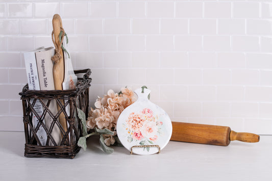 Round ceramic spoon rest styled with hydrangeas and rolling pin