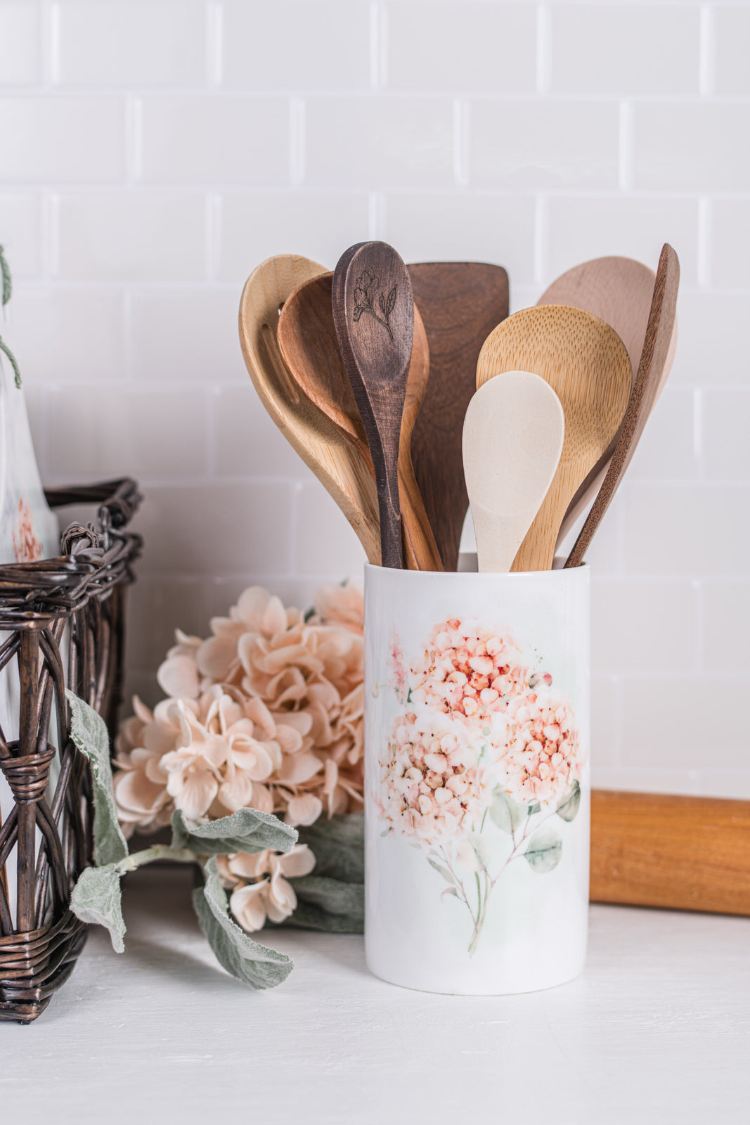 Peach and pink floral utensil holder styled in farmhouse kitchen scene