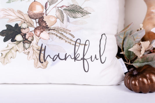 Close up of thankful script on handsewn, white velveteen Woodland pillow cover.