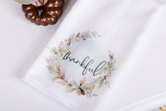 Thankful hand towel with fall wreath design styled beside faux pumpkin