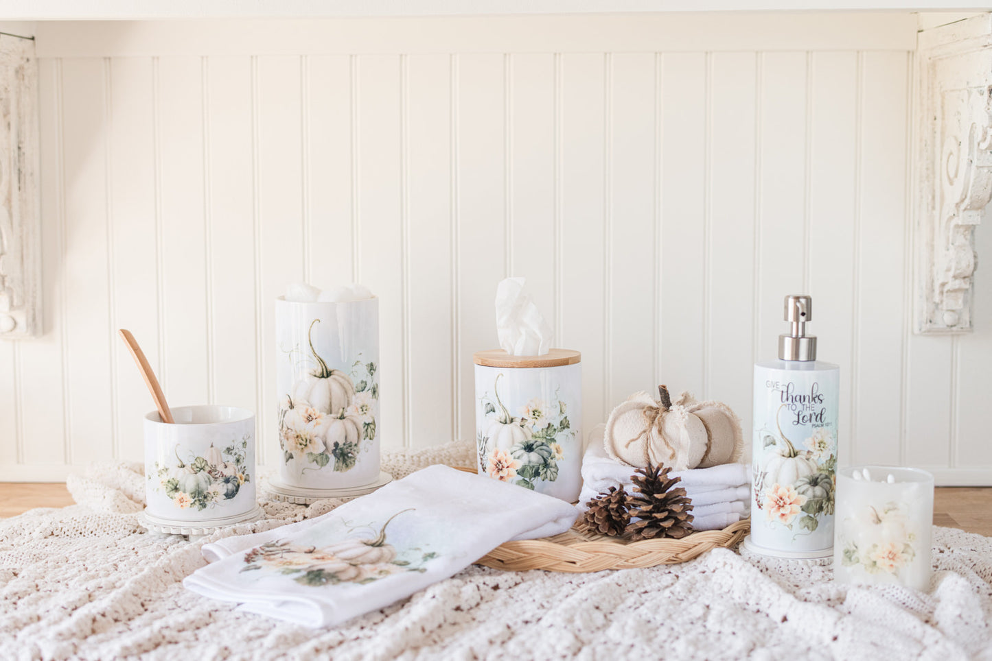 Soft fall pumpkin jars styled in a neutral bathroom with a soap dispenser and ceramic tissue holder.