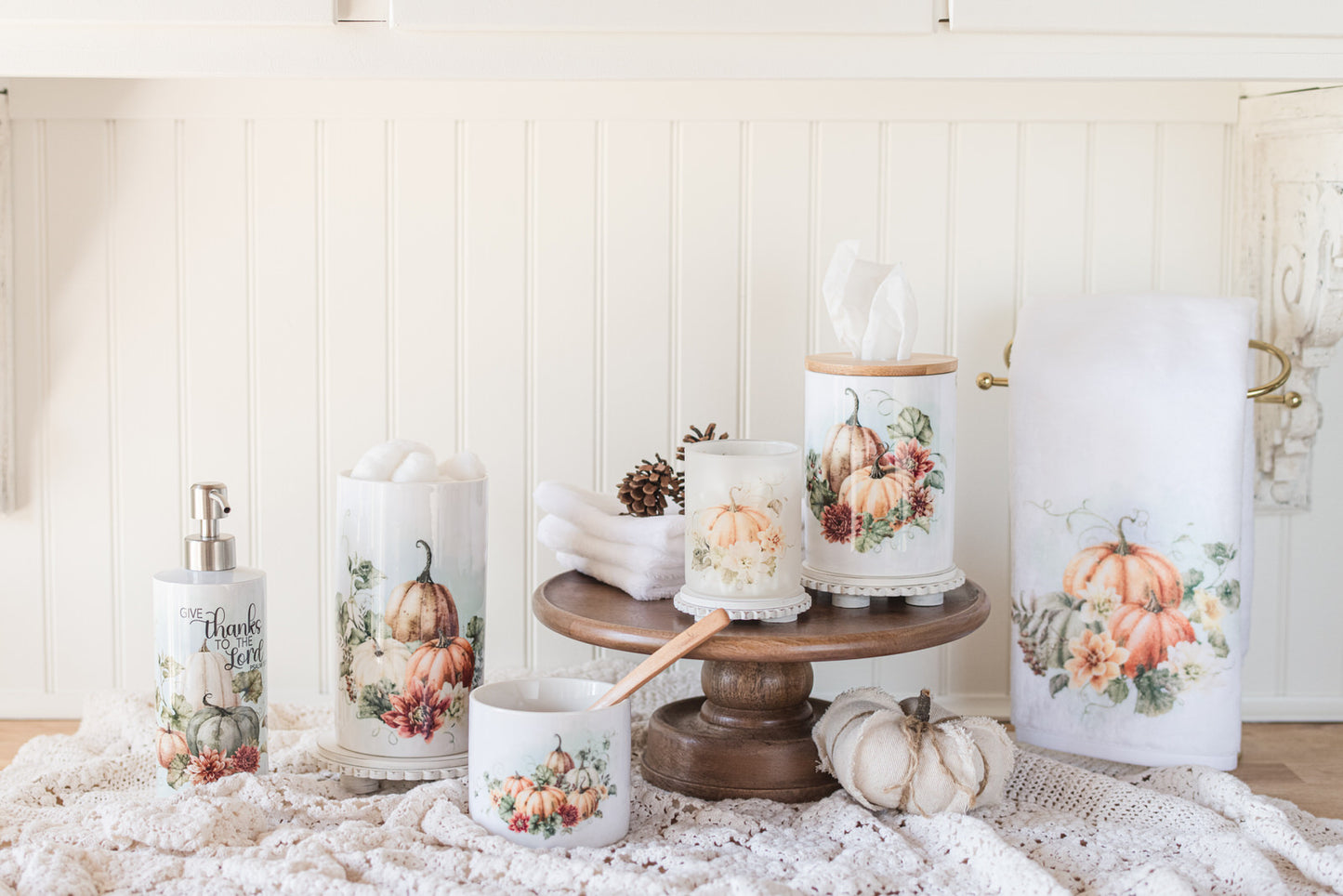 Bathroom jars for fall with guest bath decor items with pumpkin and floral designs on a counter
