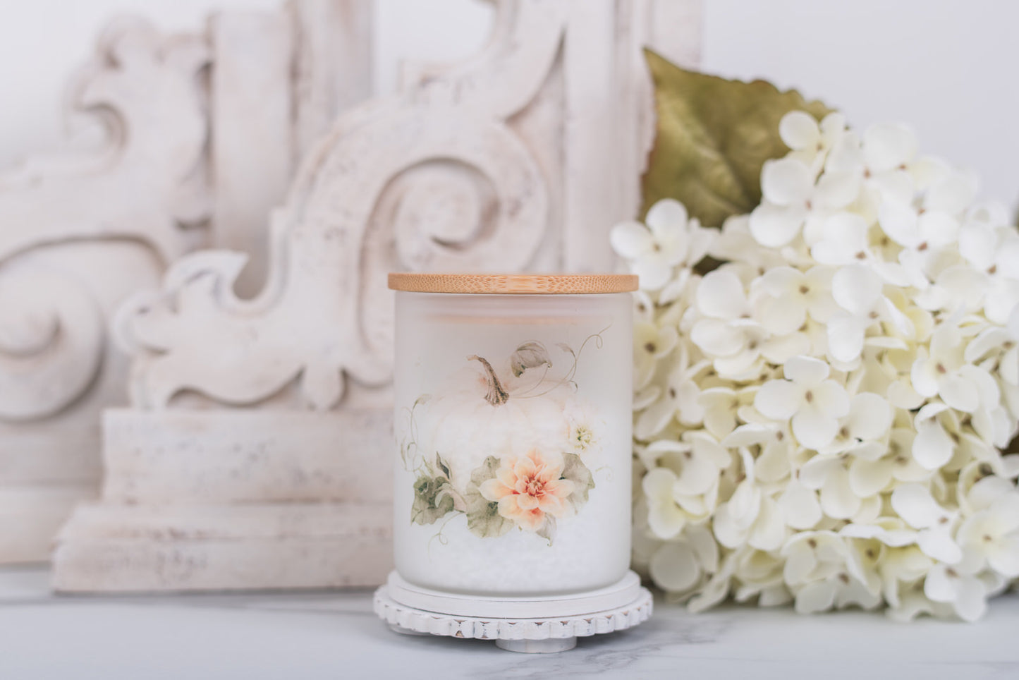 Frosted glass jar with soft white pumpkin art and bamboo lid