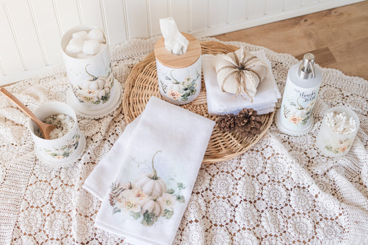 Soft fall pumpkin and floral vanity containers styled with towels and florals
