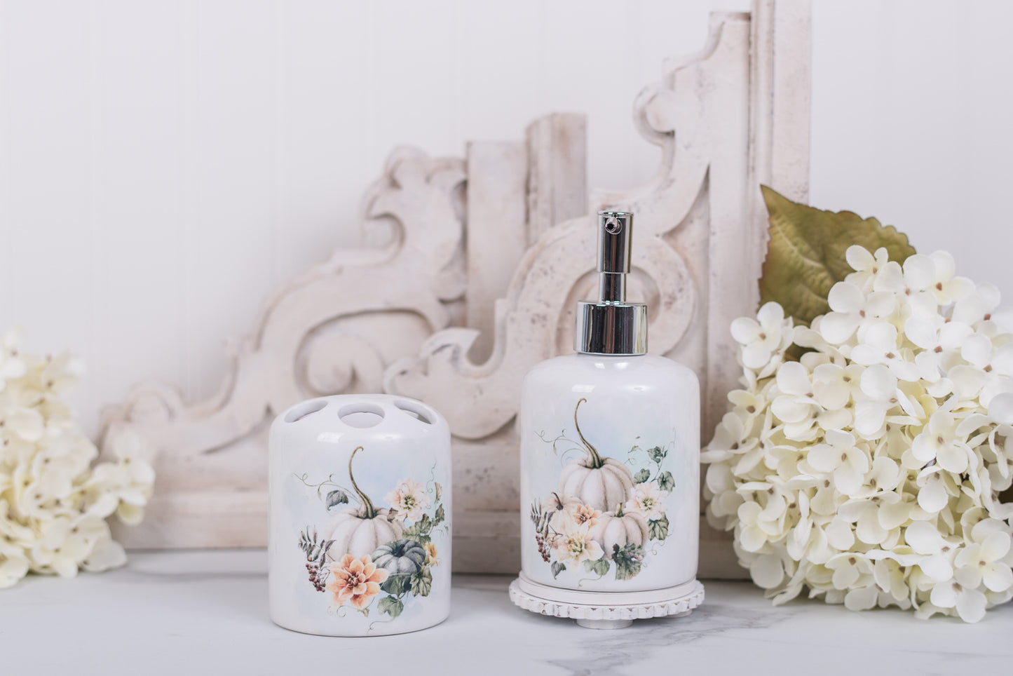 Decorative bathroom set with floral and pumpkin design on a white surface