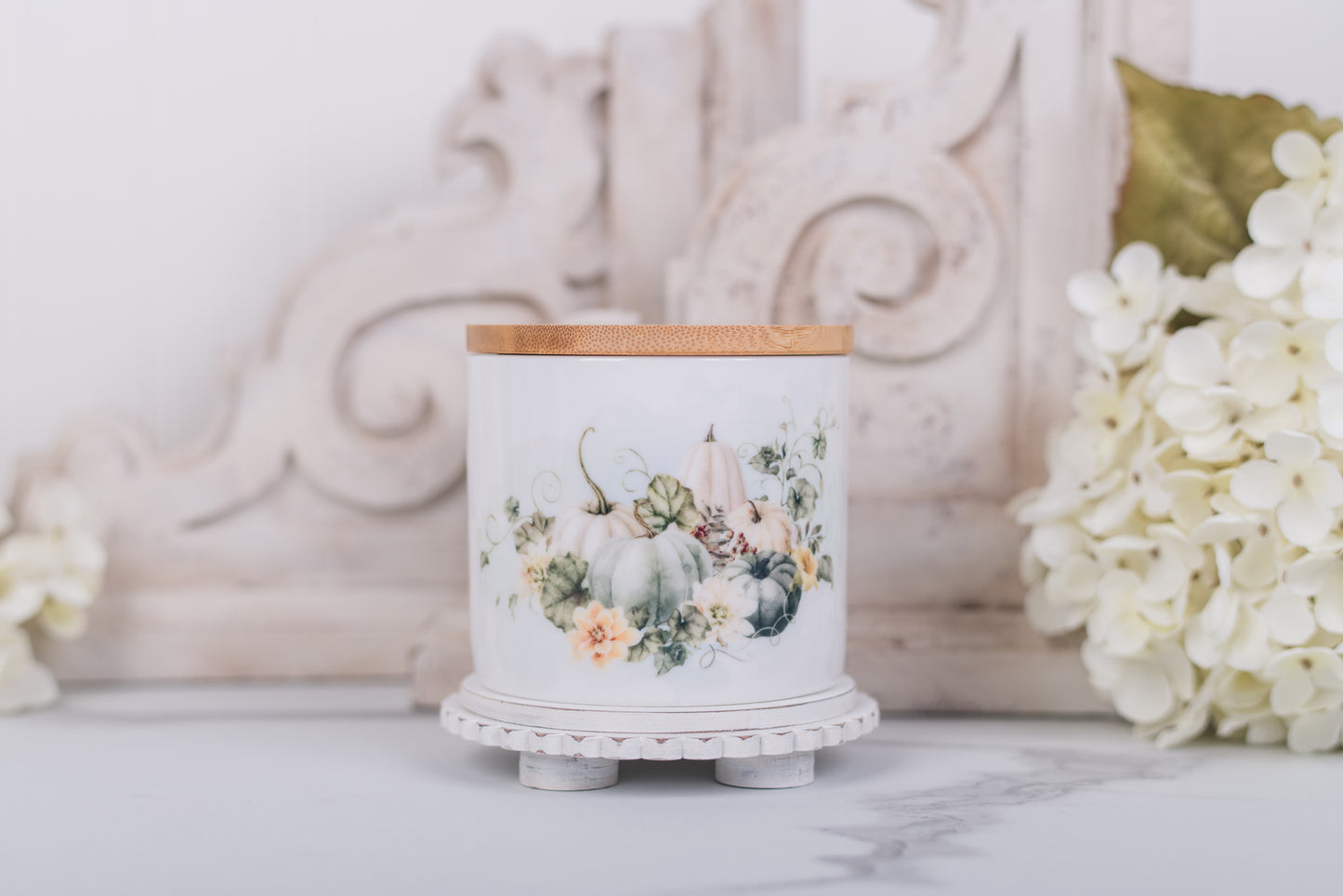 Small ceramic canister with soft white pumpkins and bamboo lid