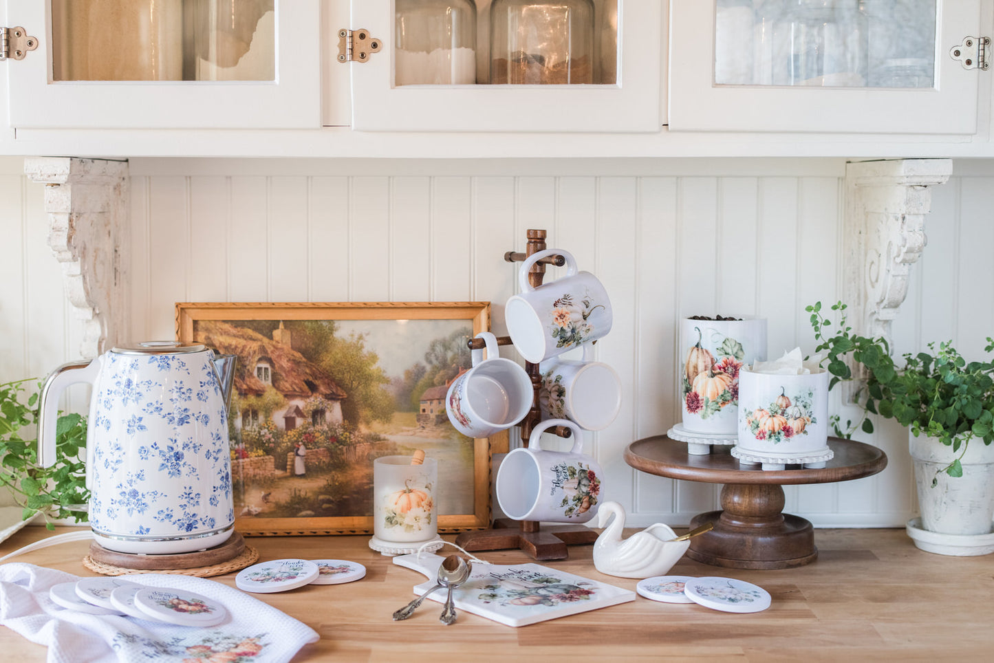 Kitchen counter with decorative items including a teapot, cups, and a painting.
