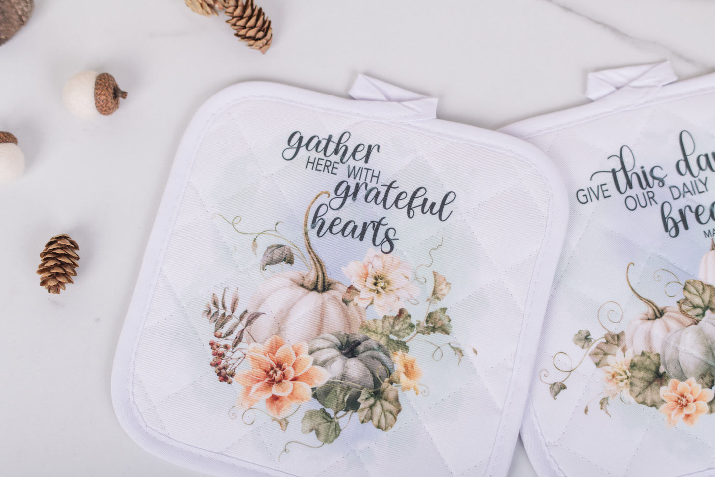 Quilted fall potholders with pastel pumpkins and floral art, with gather here with grateful hearts text