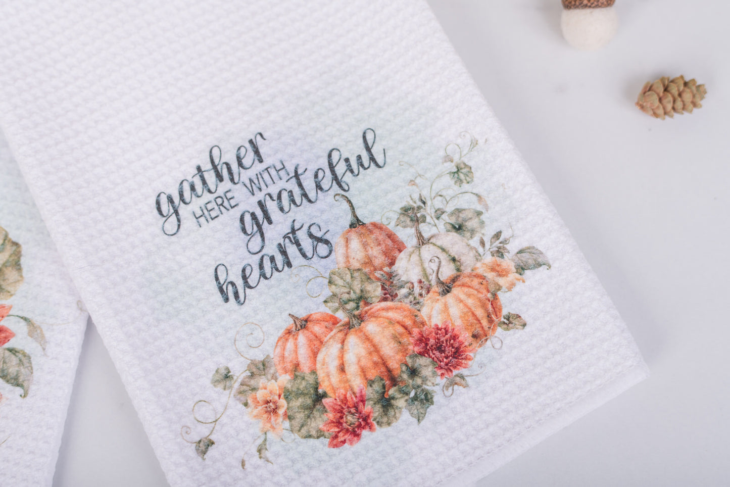 Autumn tea towels laid flat with rich floral artwork and faith-based text