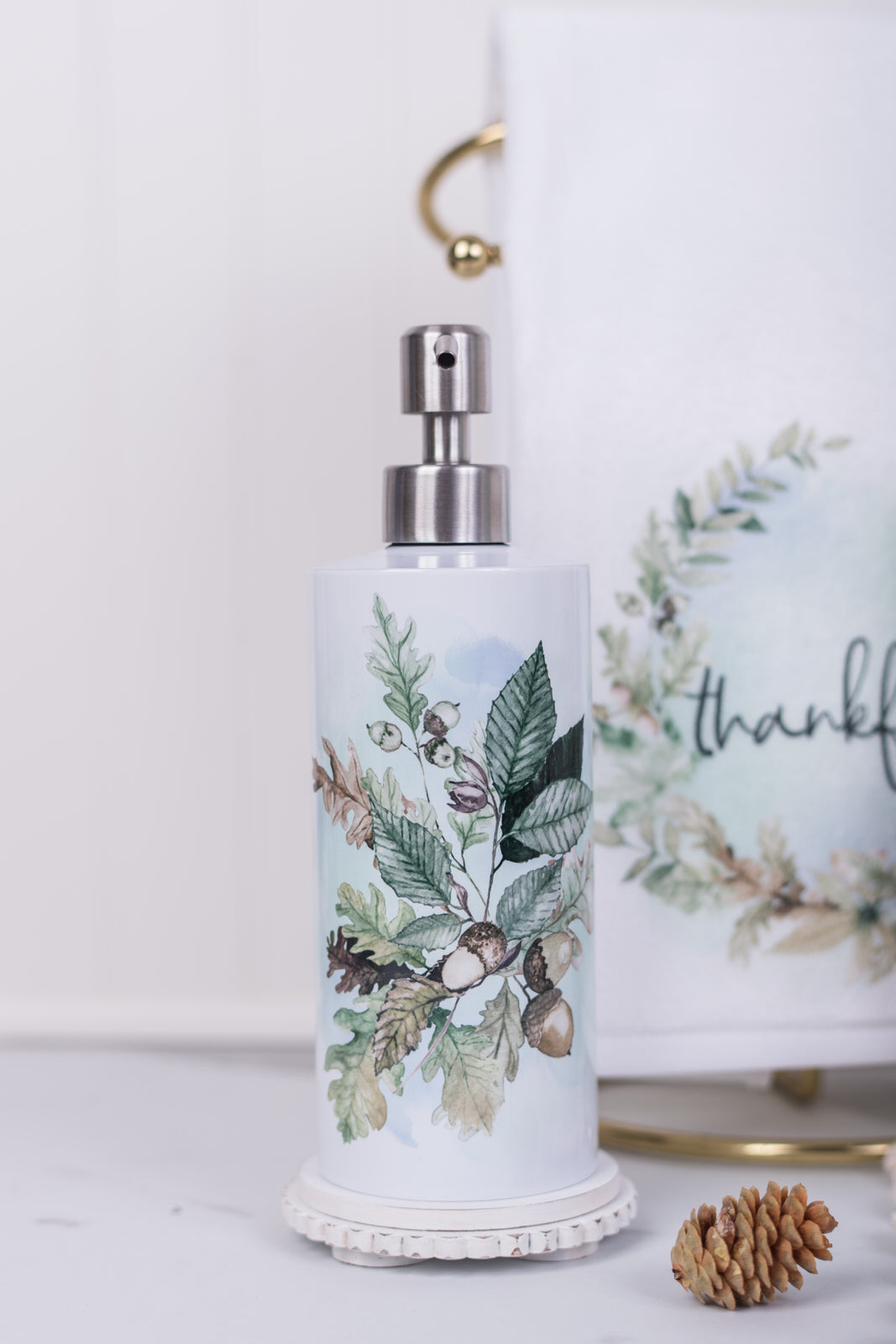 Neutral fall stainless steel dispenser beside kitchen sink with greenery