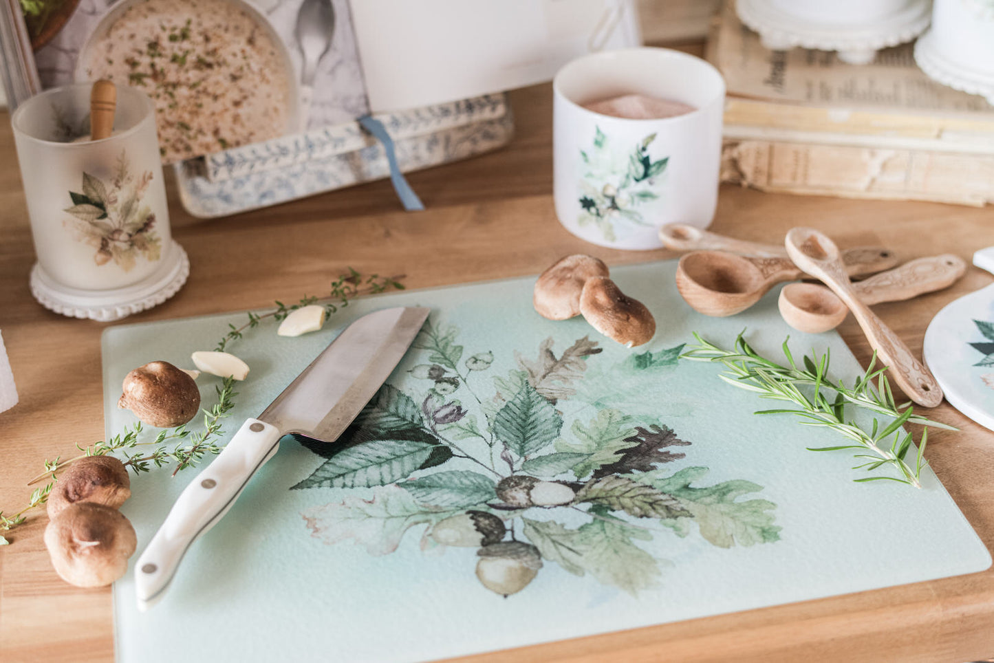Cutting board with knife and mushrooms on a wooden table with decorative items.