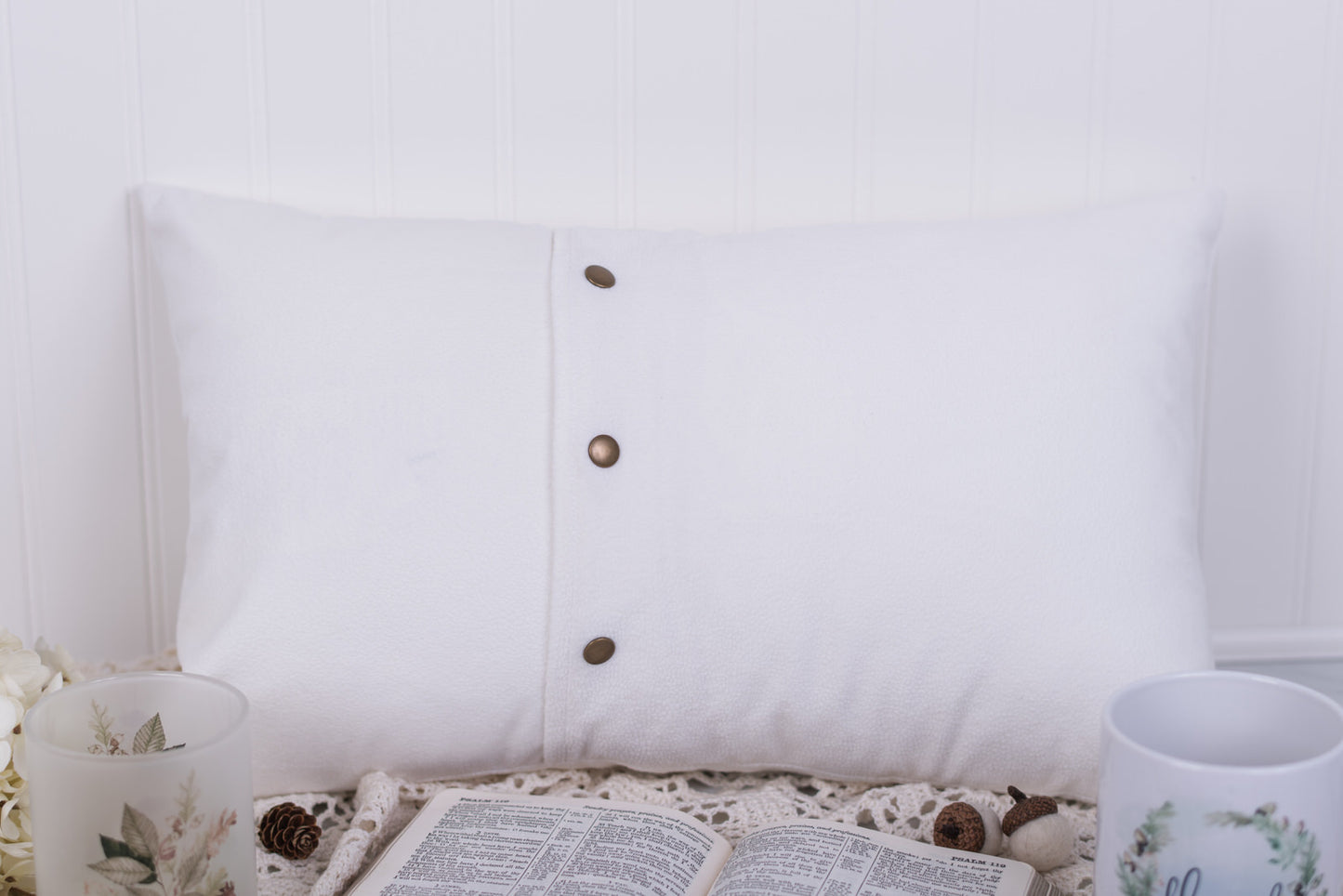 White pillow with snaps on a white background