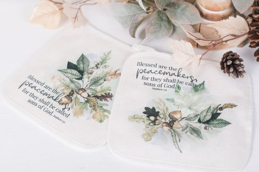 Woodland scripture pot holders with Matthew 5:9 styled in fall kitchen scene
