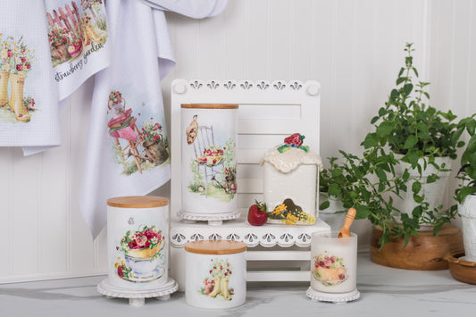 Decorative bathroom items with strawberry designs on a white surface.