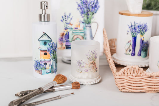 Small frosted glass canister with lavender art on a bathroom counter