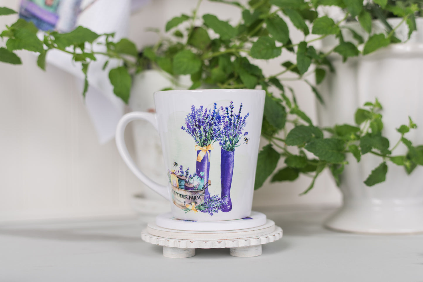 Mug with lavender design on a white surface with greenery in the background