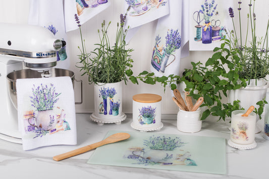 Kitchen counter with lavender-themed kitchen items including plants, towels, and utensils.
