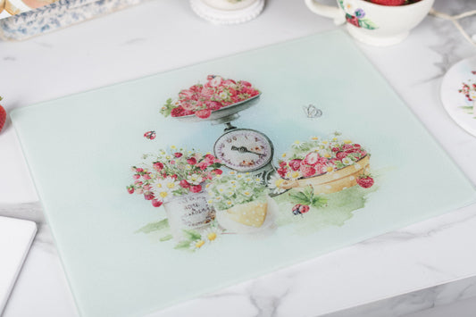 Glass strawberry cutting board styled in a cottage kitchen.