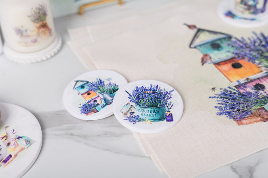 Coasters with lavender and house design on a marble surface