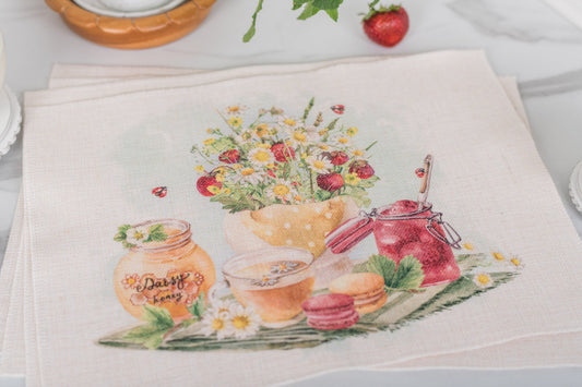 Set of four strawberry placemats on a farmhouse summer table.