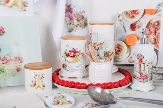 Decorative kitchen items with floral designs on a white surface