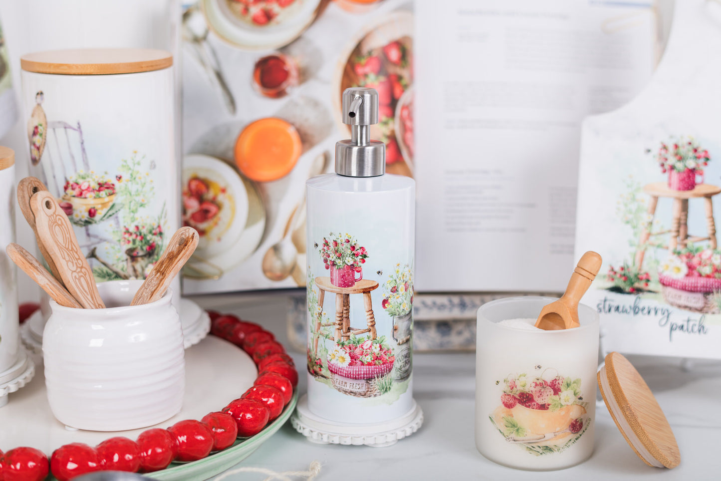 Decorative kitchen items with floral designs on a white surface.