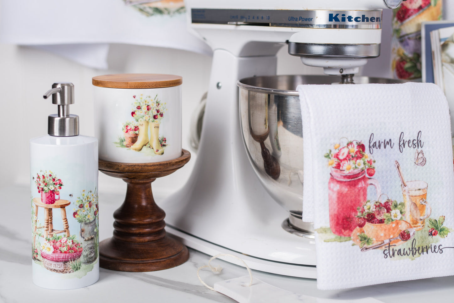 Kitchen scene with a mixer, canister, soap dispenser, and towel featuring farm fresh strawberry design.