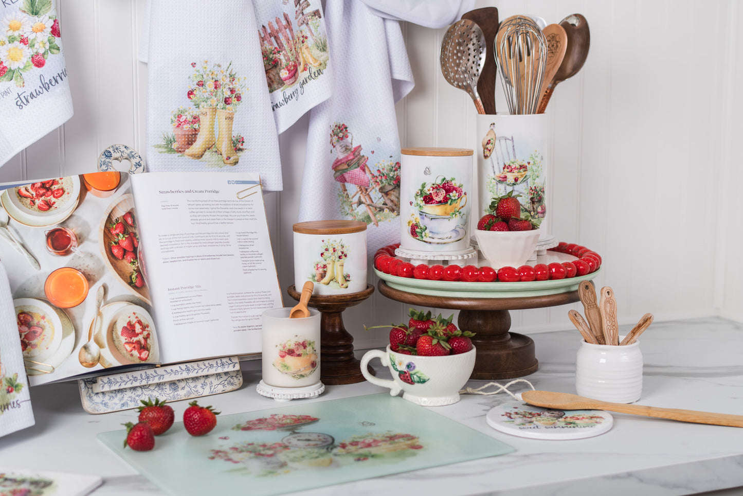 Kitchen-themed decor items including mugs, coasters, and kitchen towels with floral and fruit designs.