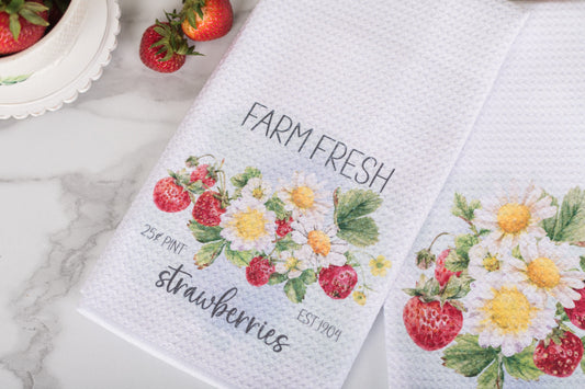 Towel with 'Farm Fresh Strawberries' design on a marble surface