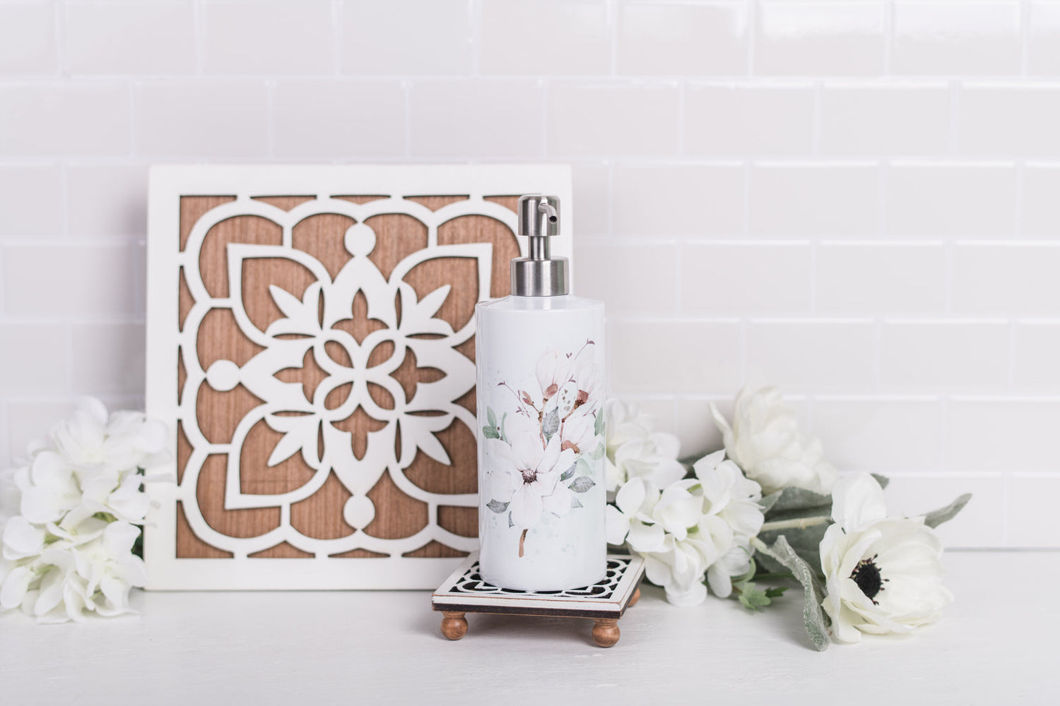 Magnolia floral soap dispenser, styled with white florals and trivet 