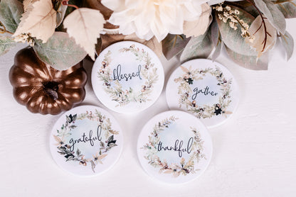 Woodland coaster set with blessed, thankful, grateful, and gather wreaths styled with fall greenery