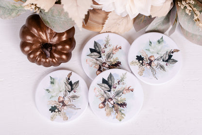 fall coasters with leafs and acorns on white table 