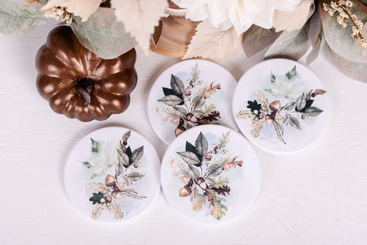 fall coasters with leafs and acorns on white table 